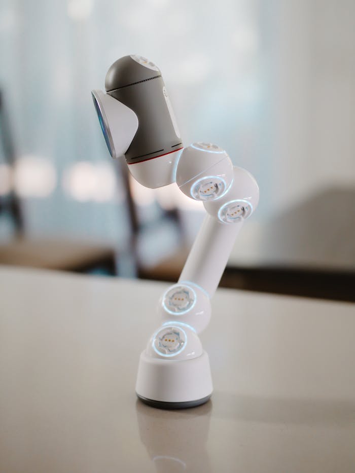 A sleek and modern robotic arm displayed on a table indoors, highlighting innovation.